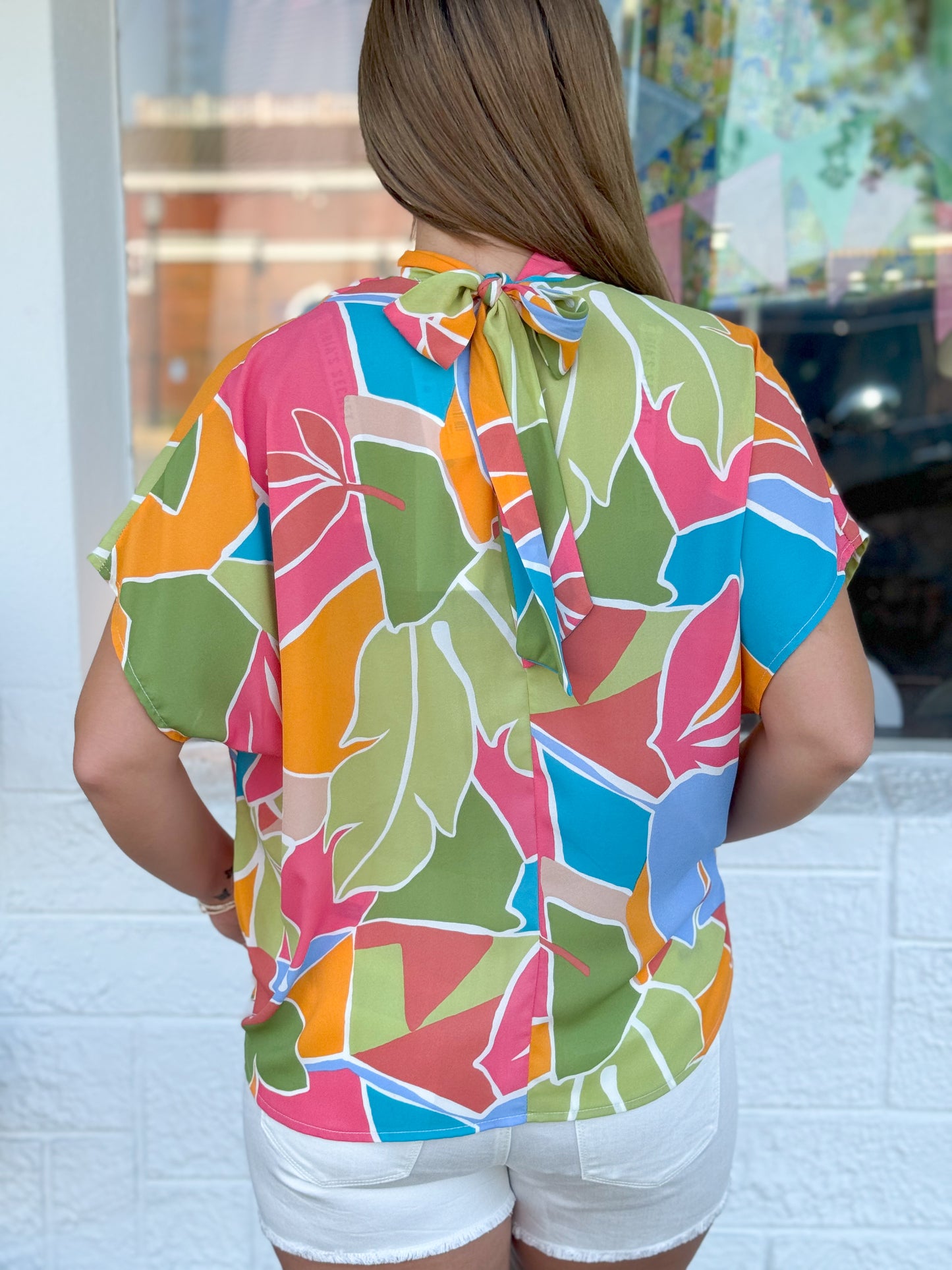 Bahama Breeze High Tie Neck Bubble Hem Top
